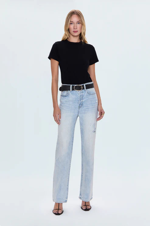 Woman wearing black cotton T-shirt with light wash jeans, casual outfit
