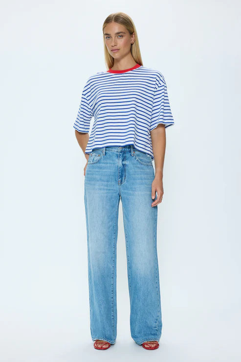 Model wearing blue and white striped T-shirt with high-waisted jeans