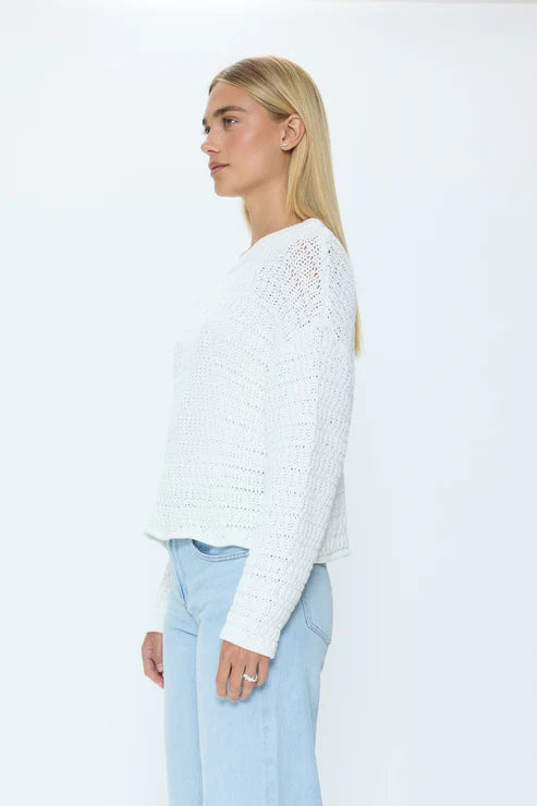 Profile of white knit crew neck sweater on model