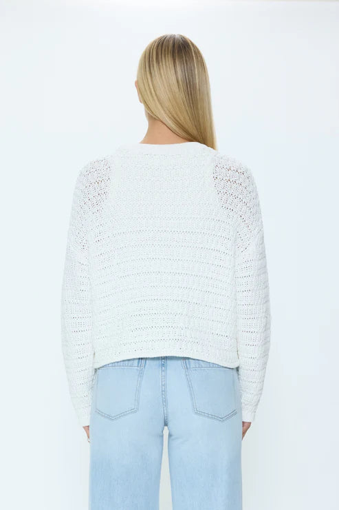Back view of white knit sweater with open weave pattern