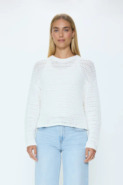 Front view of white knit crew neck sweater on model