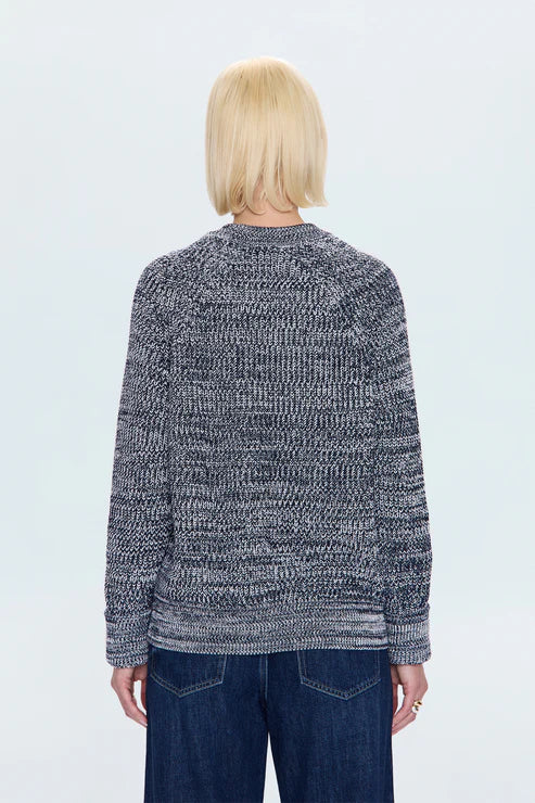 Back view of women in navy marl knit sweater, relaxed fit style