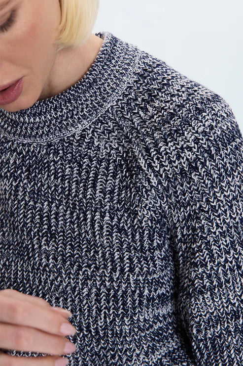Close-up of navy marl knit sweater fabric, textured knit pattern