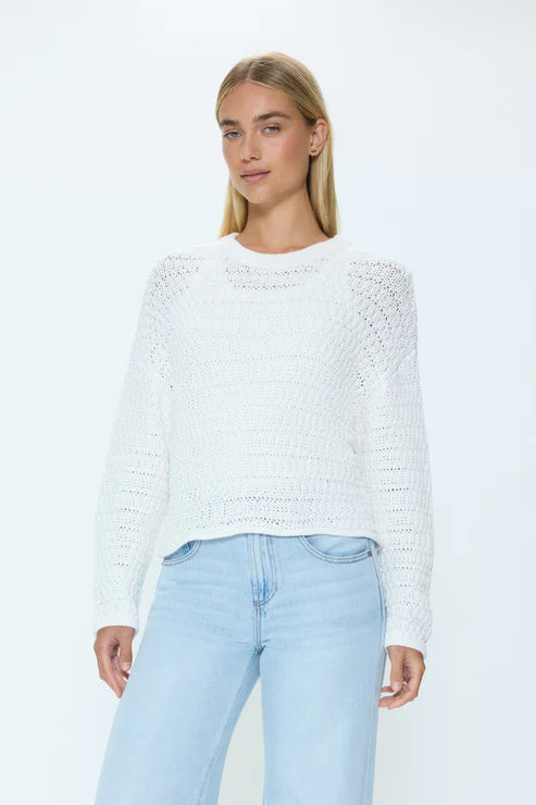 Front view of white knit sweater with relaxed fit and light wash jeans