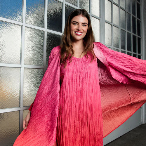 Model wearing pink handmade dress with textured fabric